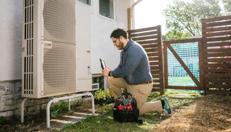 A contractor servicing a heat pump 
