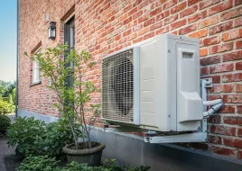 Heat pump outside brick home