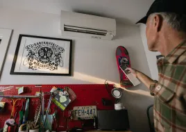 person turning on mini-split ac